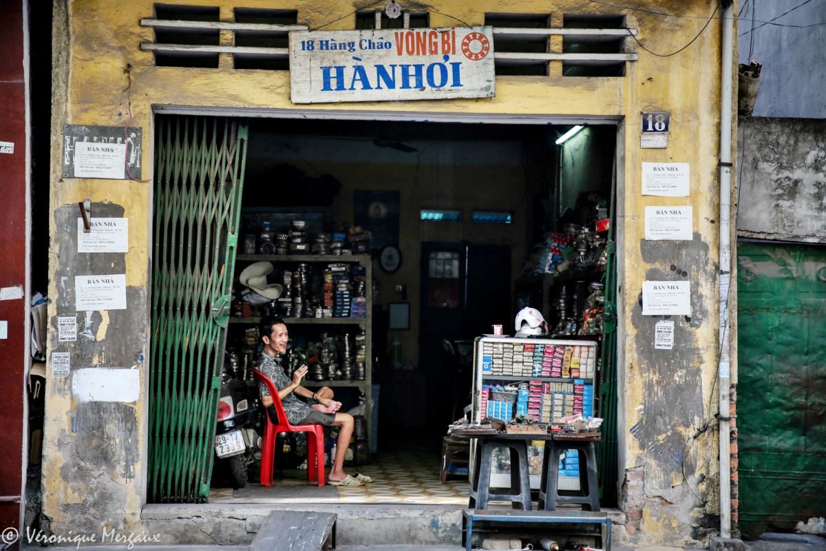 Roadside artisans, shops and taverns in Hanoi, Vietnam